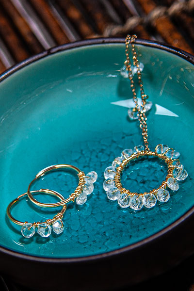 earrings and necklace in a soy sauce bowl