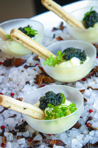 bowls of caviar with bread sticks